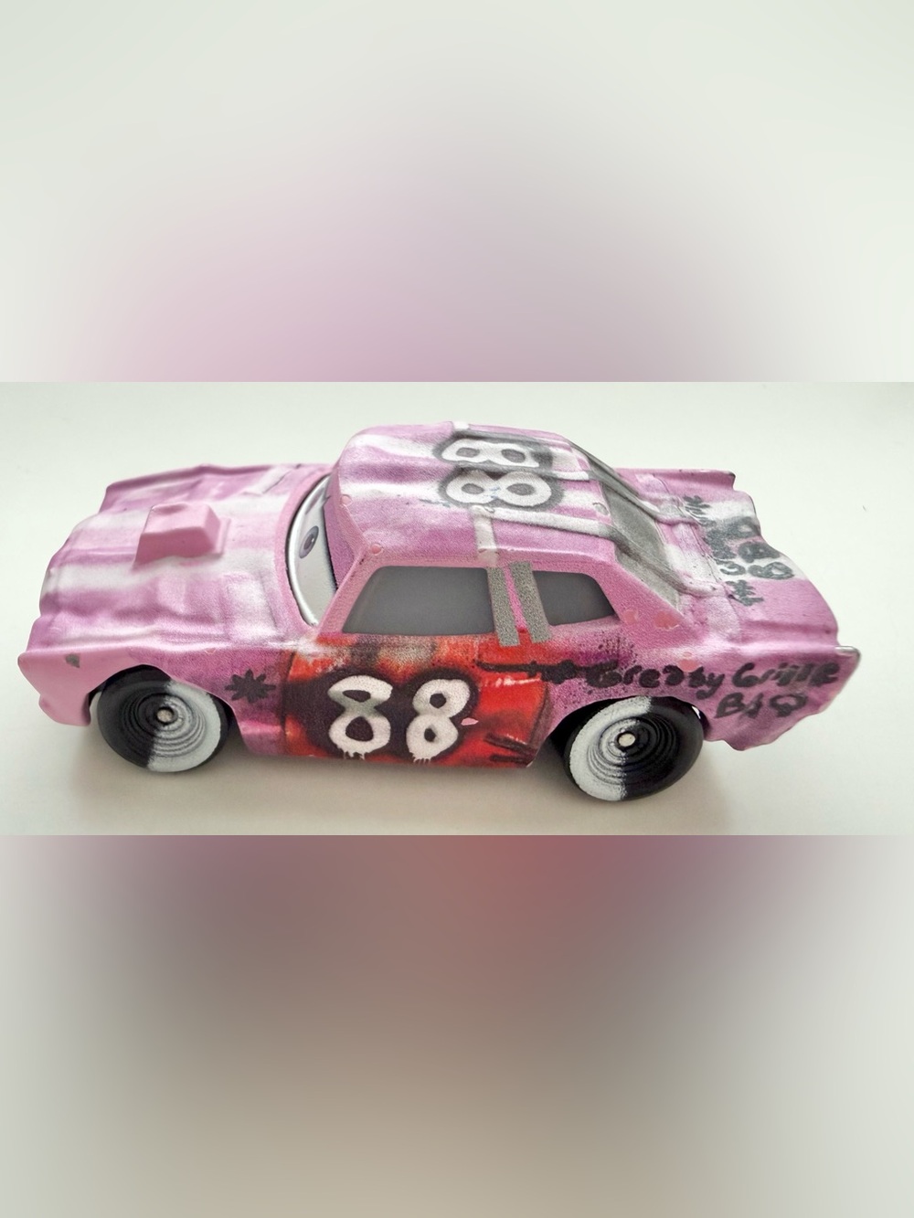 Tailgate (No. 88), a pink female demolition derby race car